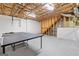 Unfinished basement with exposed ceiling insulation, concrete flooring and ping pong table at 2967 Albright Commons, Kennesaw, GA 30144