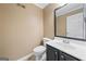 Powder room with vanity, dark cabinets, sink and mirror at 2967 Albright Commons, Kennesaw, GA 30144