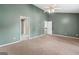 Spacious carpeted bedroom featuring a ceiling fan and doorways to other rooms at 2967 Albright Commons, Kennesaw, GA 30144
