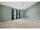 Large, carpeted bedroom with a ceiling fan, vaulted ceilings, and a window dressed with curtains at 2967 Albright Commons, Kennesaw, GA 30144