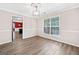 Empty dining room with hardwood floors, bright natural light and a view into the kitchen at 2967 Albright Commons, Kennesaw, GA 30144