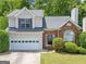 Charming two-story home featuring a brick facade, well-maintained lawn, and attached two-car garage at 2967 Albright Commons, Kennesaw, GA 30144