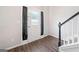 Foyer featuring hardwood floors, stairs with black banister, and a front door with sidelights at 2967 Albright Commons, Kennesaw, GA 30144