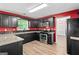 Kitchen with dark cabinets, granite countertops, stainless appliances, and hardwood flooring at 2967 Albright Commons, Kennesaw, GA 30144
