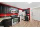 Bright kitchen features stainless steel appliances, dark cabinetry, granite countertops, and wood floors at 2967 Albright Commons, Kennesaw, GA 30144