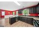 Kitchen with dark cabinets, granite countertops, stainless appliances, and hardwood flooring at 2967 Albright Commons, Kennesaw, GA 30144