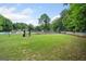 Community playground surrounded by lush greenery with swings and slide for  at 2967 Albright Commons, Kennesaw, GA 30144