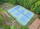 Aerial view of a community tennis court featuring three individual courts and night lighting at 2967 Albright Commons, Kennesaw, GA 30144
