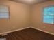 Bedroom featuring wood-look floors and two windows at 8145 Attleboro Dr, Jonesboro, GA 30238