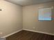 Neutral bedroom features wood-look flooring and a window for natural light at 8145 Attleboro Dr, Jonesboro, GA 30238