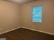 Bedroom featuring wood-look floors and a window at 8145 Attleboro Dr, Jonesboro, GA 30238