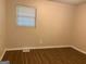 Bedroom featuring wood-look floors and a window at 8145 Attleboro Dr, Jonesboro, GA 30238