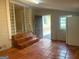 Spacious living room featuring tile flooring, access to outside, and stylish brick-and-glass accents at 8145 Attleboro Dr, Jonesboro, GA 30238