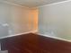 Living room with wood-look floors, neutral walls, and base molding at 8145 Attleboro Dr, Jonesboro, GA 30238