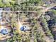 Aerial view of a modern home with a long driveway nestled amongst mature trees at 980 Temple Draketown Rd, Temple, GA 30179