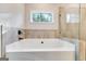 Bathtub, glass-enclosed shower, and a window offering a scenic view in this well-lit bathroom at 980 Temple Draketown Rd, Temple, GA 30179