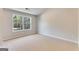 Bedroom with neutral colored walls, carpet, and a window letting in natural light at 980 Temple Draketown Rd, Temple, GA 30179