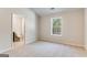 Bedroom featuring neutral walls, carpet, a window, and an ensuite bathroom at 980 Temple Draketown Rd, Temple, GA 30179