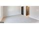 Neutral bedroom features plush carpet, light gray walls, and a black door with matching hardware at 980 Temple Draketown Rd, Temple, GA 30179