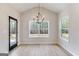Bright dining area featuring a modern chandelier, large windows, and easy access to the outdoors at 980 Temple Draketown Rd, Temple, GA 30179