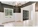 Dining room with view to front yard has modern lighting, neutral paint, and wood-look floor at 980 Temple Draketown Rd, Temple, GA 30179
