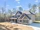 New construction home featuring a side-entry garage, large lawn, and wooded lot at 980 Temple Draketown Rd, Temple, GA 30179