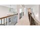 Bright hallway features modern lighting fixtures, dark wood railing, and views to other levels at 980 Temple Draketown Rd, Temple, GA 30179