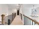Second floor hallway with hardwood railing and modern chandelier at 980 Temple Draketown Rd, Temple, GA 30179