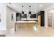 Modern kitchen featuring dark cabinets, a large center island with pendant lighting and stainless steel appliances at 980 Temple Draketown Rd, Temple, GA 30179