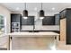 Stylish kitchen showcasing dark cabinets, a large island, quartz countertops, and stainless steel appliances at 980 Temple Draketown Rd, Temple, GA 30179