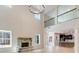 Spacious living room with stone fireplace, large windows, high ceiling, and open layout to the kitchen at 980 Temple Draketown Rd, Temple, GA 30179