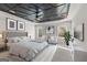 Elegant primary bedroom with coffered ceiling, natural light, and stylish decor creating a serene retreat at 980 Temple Draketown Rd, Temple, GA 30179