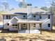 Rear exterior of the home, showcasing a large covered patio and well-manicured yard at 980 Temple Draketown Rd, Temple, GA 30179