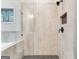 Close-up of a glass-enclosed shower, showing tile accents, black fixtures, and shower niche at 980 Temple Draketown Rd, Temple, GA 30179