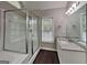 Modern bathroom with a glass-enclosed shower, granite countertops, and ample lighting at 2001 Fairbrook Ln, Woodstock, GA 30189