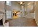 Open living room with vaulted ceilings, a fireplace, and a view of the kitchen and staircase at 2001 Fairbrook Ln, Woodstock, GA 30189