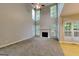 Bright living room with a fireplace, large windows, and an open floor plan at 2001 Fairbrook Ln, Woodstock, GA 30189
