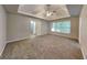 Large main bedroom featuring a tray ceiling, ceiling fan, and access to an ensuite bathroom at 2001 Fairbrook Ln, Woodstock, GA 30189