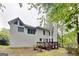 Backyard exterior with a wooden deck and partial view of the home nestled among the trees at 2001 Fairbrook Ln, Woodstock, GA 30189