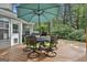 Back deck featuring a dining table with seating, an umbrella, and a grill at 908 Huntington Pl, Peachtree City, GA 30269