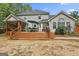 Back exterior of the home showcasing a large deck with multiple seating areas at 908 Huntington Pl, Peachtree City, GA 30269