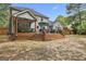 Back exterior of home with a spacious deck, outdoor seating, and a grill at 908 Huntington Pl, Peachtree City, GA 30269
