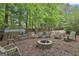 Back yard featuring a firepit with seating and a shed at 908 Huntington Pl, Peachtree City, GA 30269
