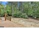 Back yard with view of landscaping and a brick path from the deck at 908 Huntington Pl, Peachtree City, GA 30269