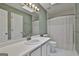 Bathroom with a white vanity, a large mirror with lighting, and a shower with white curtain at 908 Huntington Pl, Peachtree City, GA 30269