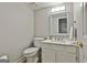 Charming half bathroom with traditional fixtures and a decorative mirror at 908 Huntington Pl, Peachtree City, GA 30269