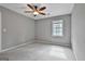 Bedroom with neutral paint, ceiling fan, a window, and a carpeted floor at 908 Huntington Pl, Peachtree City, GA 30269