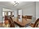 Elegant dining room featuring hardwood floors and an open floor plan to the living area at 908 Huntington Pl, Peachtree City, GA 30269