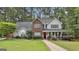 Charming two-story home with a brick facade, a welcoming front porch, and manicured landscaping at 908 Huntington Pl, Peachtree City, GA 30269