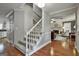Inviting foyer features hardwood flooring, a staircase, and transitions into the living room at 908 Huntington Pl, Peachtree City, GA 30269